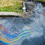 Oils being carried by runoff into stormdrain